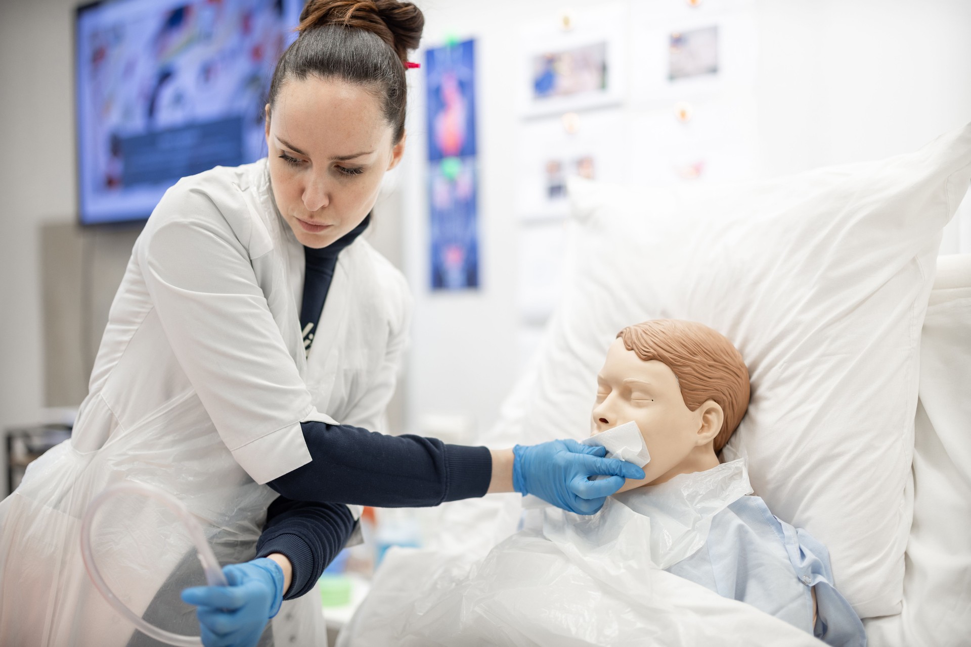 Healthcare Professional Demonstrating Patient Care with a Medical Training Dummy