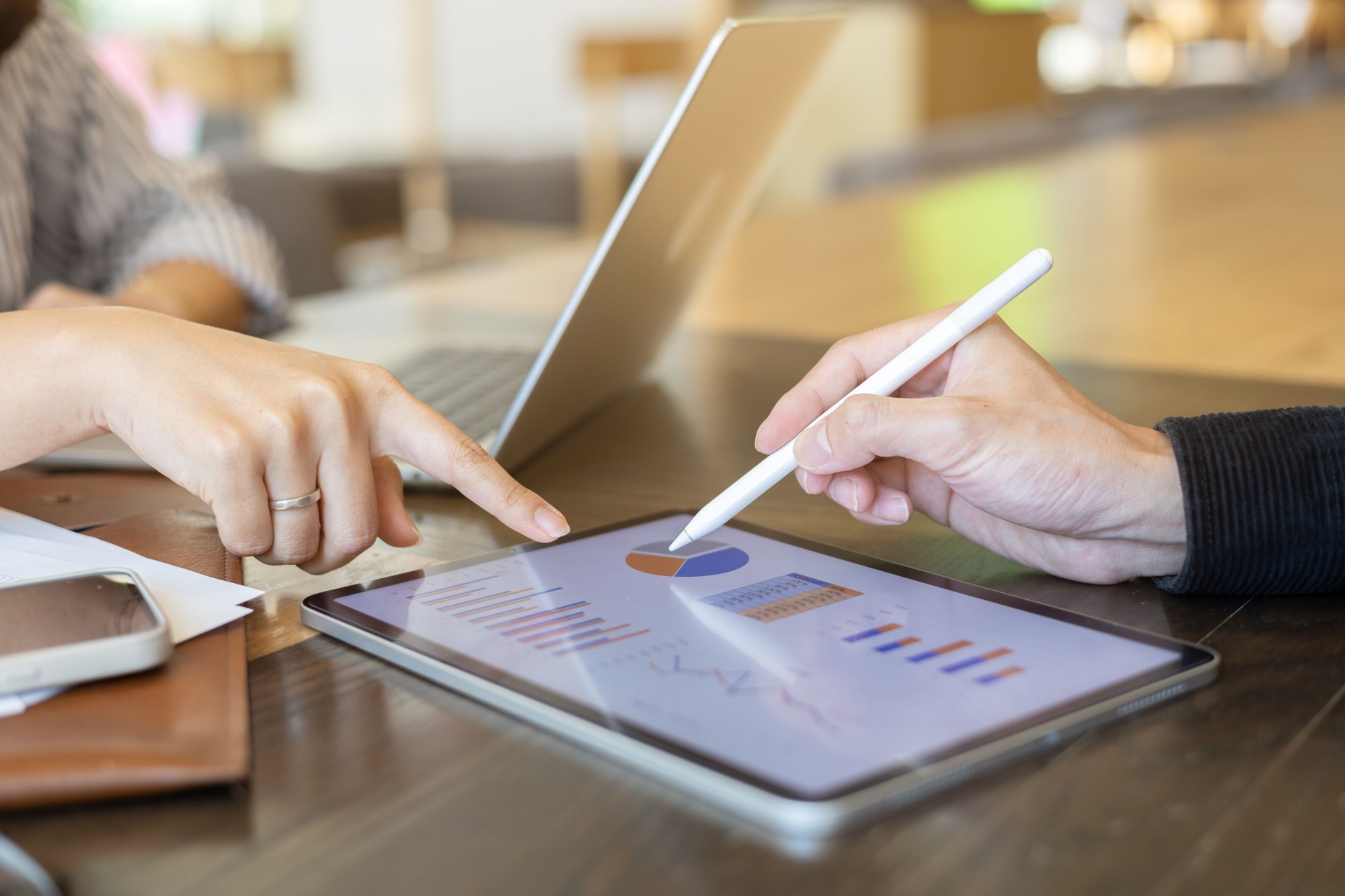 close up ceo or exceutive man hand use stylus to point on dashboard screen tablet device for check and share planning or consulting with businesswoman partner for business team and work from home concept