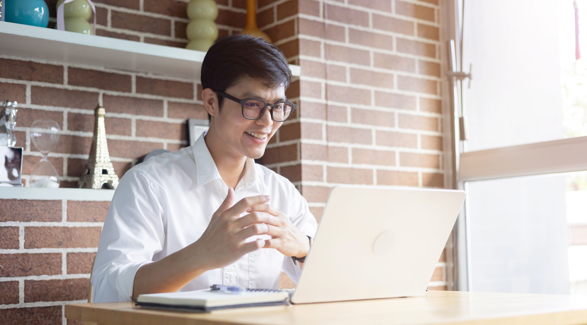 close up new graduated asian man talking or answer question by video conference call with reviewer (HR) for introduce and do job interview online in living room at house for we're hiring concept